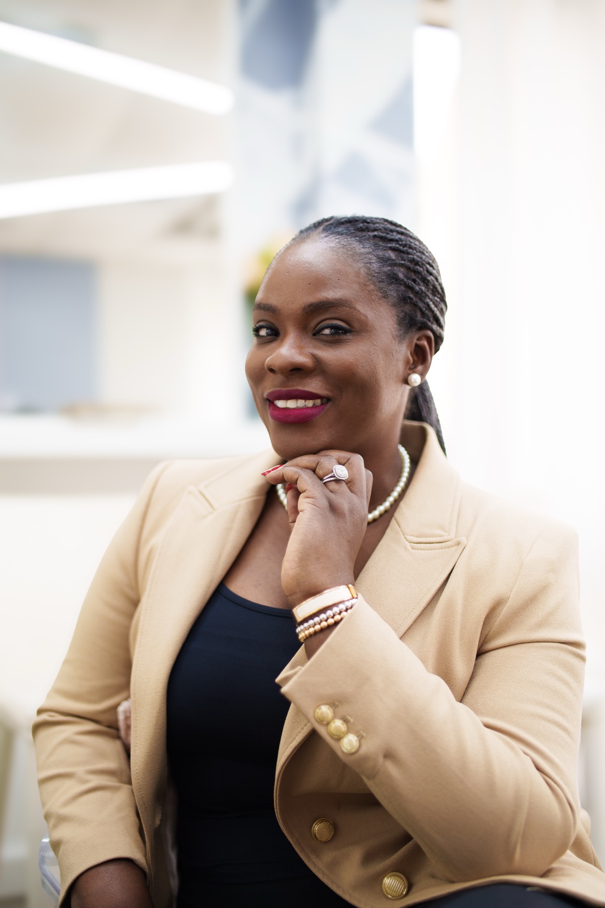 Chika Idoko in a gold blazer, smiling warmly